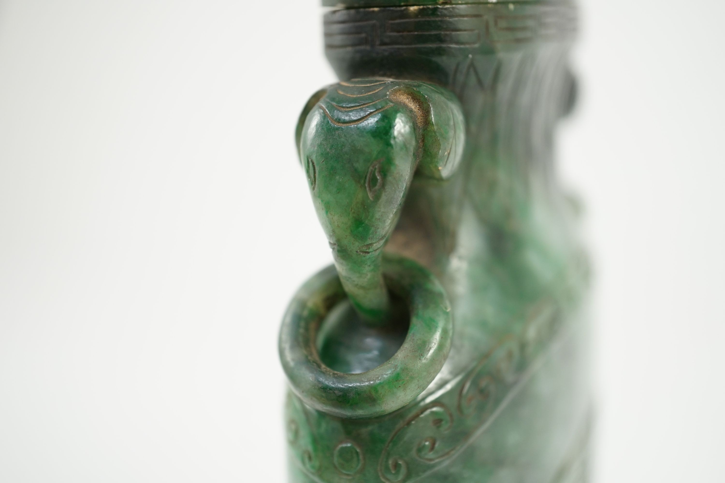 A Chinese archaistic green jadeite vase and cover, late Qing dynasty, 14.5 cm high, Silver wire inlaid wood stand, cover finial missing